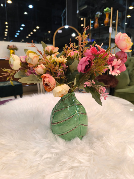 Green ceramic vase with flowers